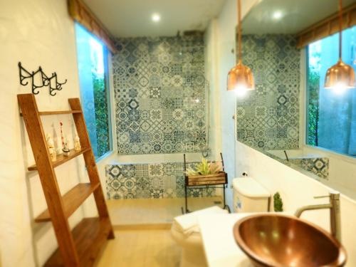 a bathroom with a sink and a toilet at Costa Village Pool Villa in Jomtien Beach