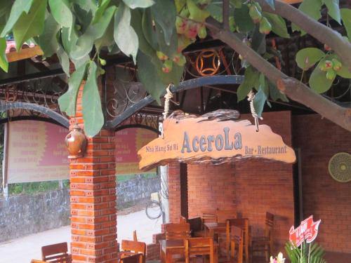a sign for a restaurant with tables and chairs at Gia Thanh Phu Quoc Guest House in Phu Quoc