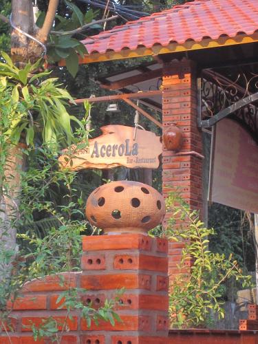 a sign for an acociosa cafe on a brick building at Gia Thanh Phu Quoc Guest House in Phu Quoc