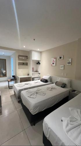 a hotel room with two beds and a kitchen at True América apart-hotel in Campos dos Goytacazes