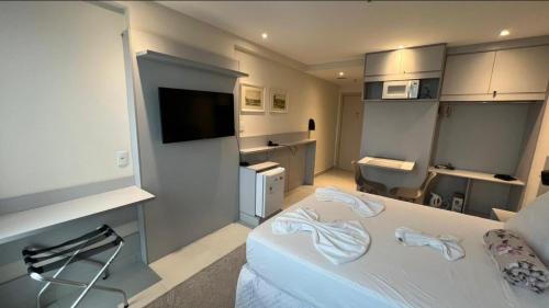 a room with a bed and a tv and a bathroom at True América apart-hotel in Campos dos Goytacazes