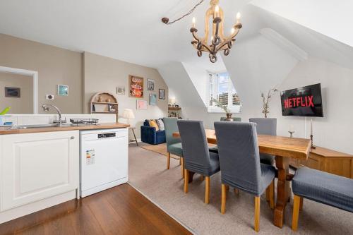a kitchen and dining room with a table and chairs at Charming Luxury Apartment Peak District in Matlock