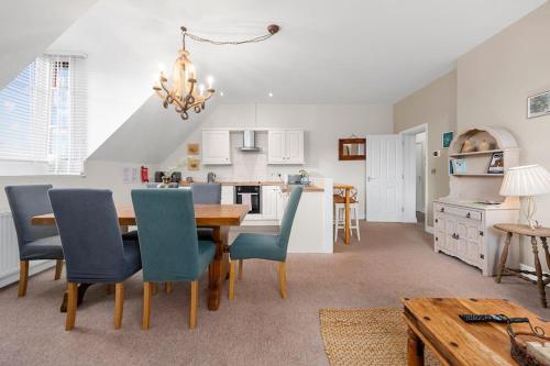 a kitchen and dining room with a table and chairs at Charming Luxury Apartment Peak District in Matlock