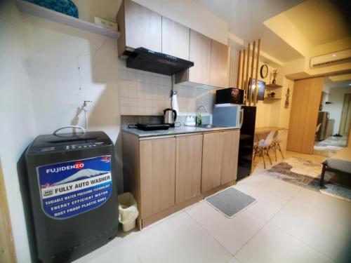 a kitchen with a sink and a stove top oven at Simple Haven at Inspiria Davao Beside Abreeza Mall - Fully Equipped Studio in Davao City