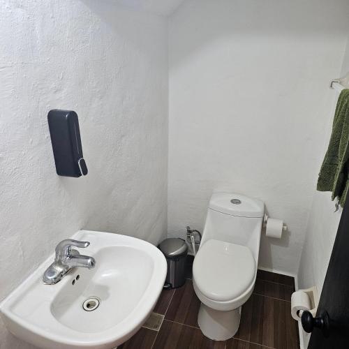 a bathroom with a white toilet and a sink at Casa Marina, Playa y Aeropuerto cerca in Puerto Vallarta