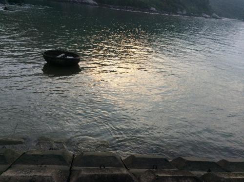 a boat sitting in the middle of a body of water at Cham Island Smiles Homestay in Tân Hiệp