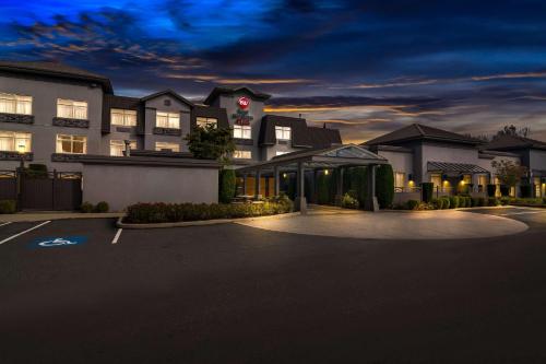 a building with a parking lot in front of it at Best Western Plus Pitt Meadows Inn & Suites in Pitt Meadows