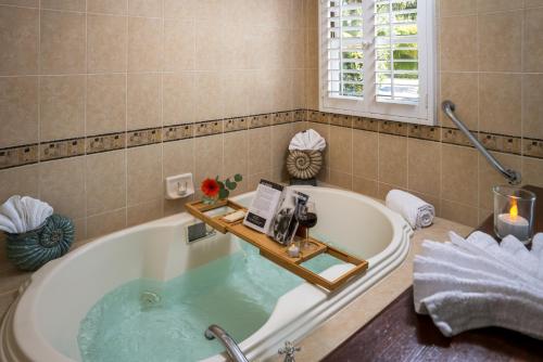 a bathroom with a bath tub with a book on it at The Eagle Inn in Santa Barbara