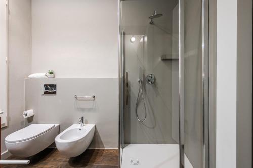 a bathroom with a shower and a toilet and a sink at Casa del Cinema in Modena