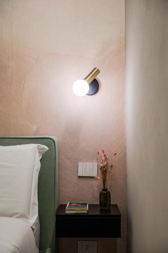 a bedroom with a bed and a lamp on a table at Casa del Cinema in Modena