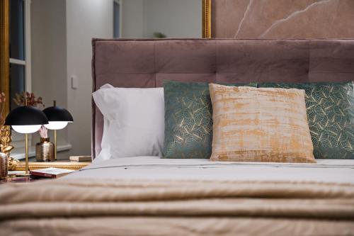 a bedroom with a bed with pillows and a table at Casa del Cinema in Modena