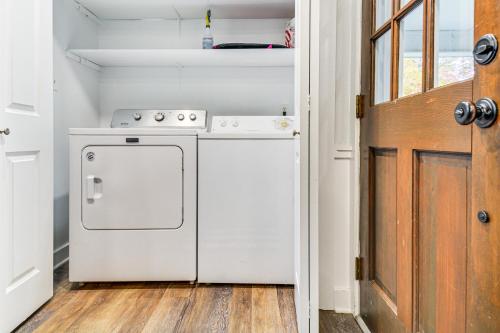 a small kitchen with a stove and a door at Walk to Parks and Town Square Cary Home with Yard! in Cary