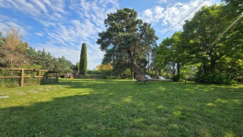 a park with a bench in the grass at Amore in Chianti in Greve in Chianti