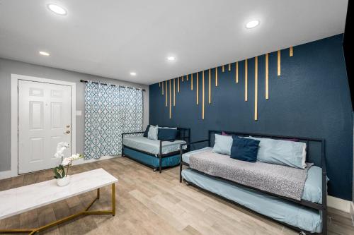 a living room with two beds and a couch at 1 BR Apt in Heights with Pool and Free Park in Houston