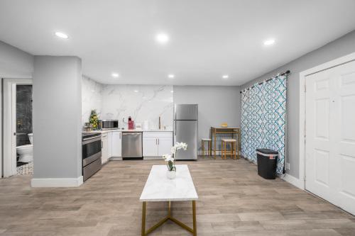 a kitchen with a table in the middle of it at 1 BR Apt in Heights with Pool and Free Park in Houston