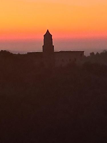 a silhouette of a building with a sunset in the background at The Mandarine, Orangery Retreat in Tursi
