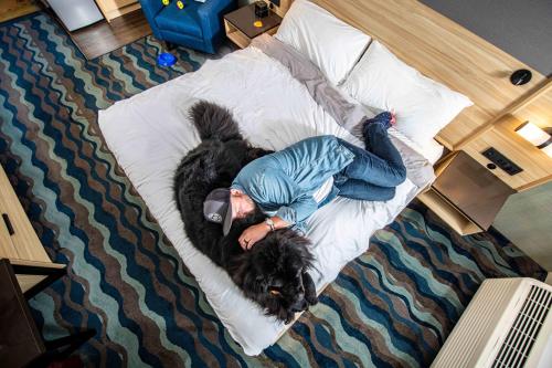 a woman laying on a bed on a pillow at Accent Inns Vancouver Airport in Richmond