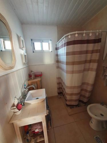a small bathroom with a sink and a shower at Casa en Chapa in La Estafeta
