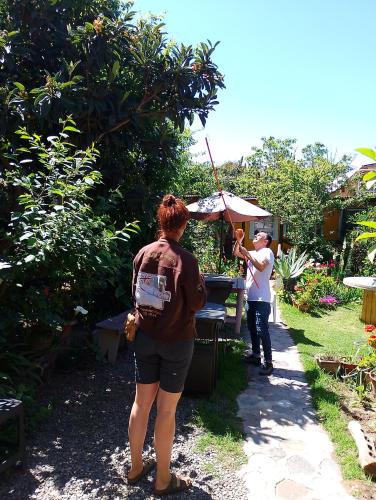 a woman holding an umbrella next to a man at Hostal Maria Casa in La Serena