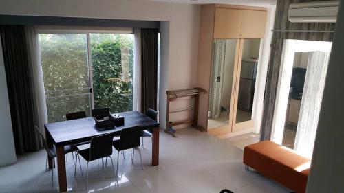 a dining room with a table and chairs in a room at Teddy Bear Villa Hua Hin in Cha Am