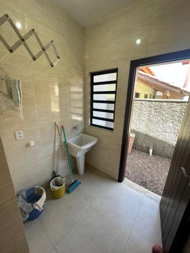 a bathroom with a sink and a toilet in it at Barra de Ibiraquera in Barra de Ibiraquera
