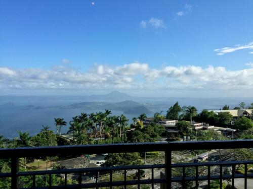 a view of the ocean from a resort balcony at Summit Ridge Tagaytay - Newly Renovated in Tagaytay