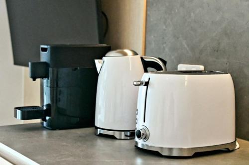 two toasters sitting on top of a kitchen counter at RiverView GetAway in Maroochy River