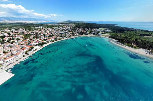 an aerial view of a beach and a city at Apartments by the sea Novalja, Pag - 11512 in Novalja