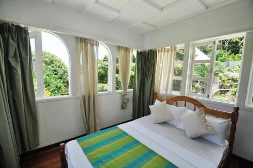 Postel nebo postele na pokoji v ubytování Petit Baie Chalets
