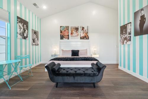 a bedroom with a bed and a couch at The Hollywood Mansion in Hurricane