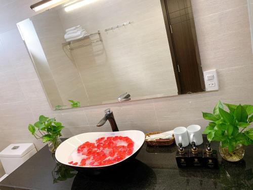 a bathroom with a sink with fruit in it at EasyLife Villa Hoi An in Tân Thành (1)