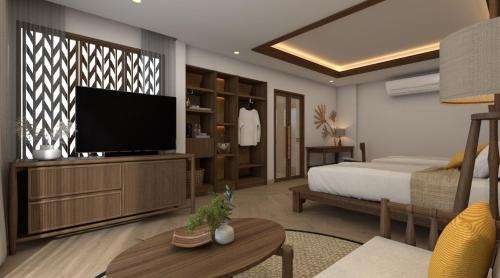a bedroom with a bed and a flat screen tv at Railay Bay Resort & Spa in Railay Beach
