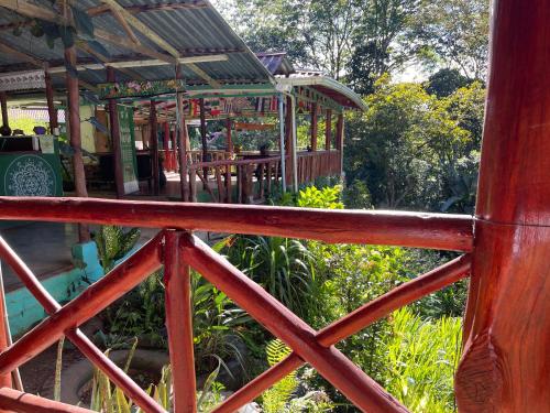 a wooden fence with a pavilion in a garden at Centro Ecológico Montaña Verde in Rivas