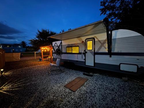 an rv parked in a parking lot at night at Costa Del Encanto Camper RV in Betances