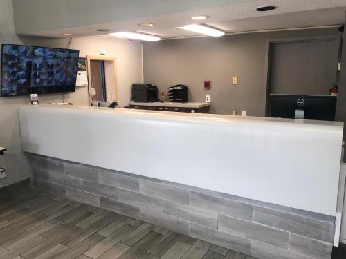 a large white counter in a room with at American Inn and Suites - Atlanta Airport Jonesboro I-75 in Jonesboro