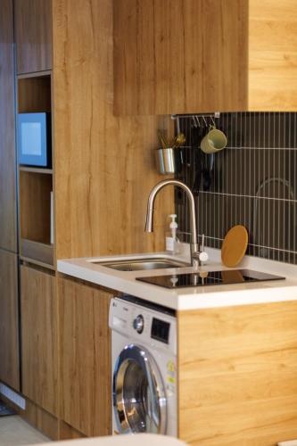 a kitchen with a sink and a washing machine at WECO STAY Insadong in Seoul