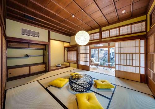a room with yellow pillows and a table in a room at NIPPONIA Sawara Merchant Town Hotel in Katori
