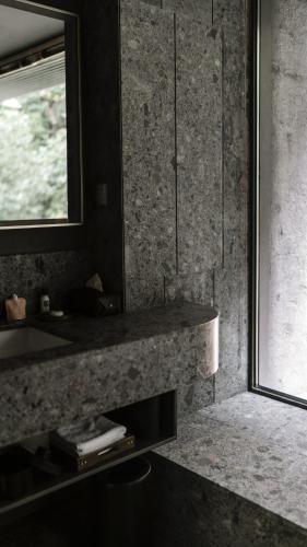 a bathroom with a sink and a mirror at Yakamoz Qianchuan Hotel in Lin'an