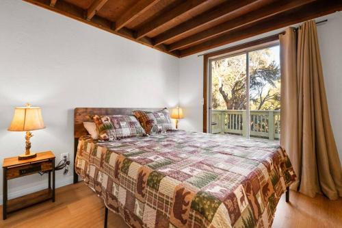a bedroom with a large bed and a window at The Beary Cozy Cabin, Huge Snow Play Area! in Sugarloaf