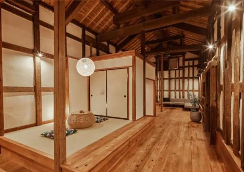 a large room with wooden floors and wooden ceilings at NIPPONIA Sawara Merchant Town Hotel in Katori