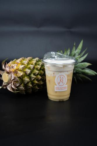 a cup of coffee next to a pineapple at Angkor Mansion & Residence in Siem Reap