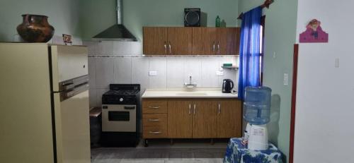a small kitchen with a sink and a refrigerator at Rancho Grande in Santa María