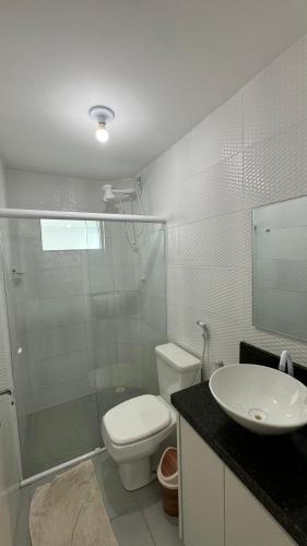a bathroom with a shower and a toilet and a sink at Maragogi Peroba Ville Residence in Maragogi