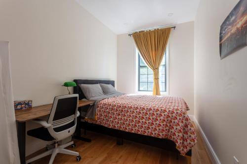 a bedroom with a bed and a desk and a computer at Little manhattan near Time Square in New York