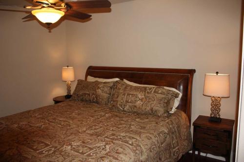 a bedroom with a bed with two night stands and two lamps at Rockin' B Ranch Creek View Barndominium in Pipe Creek