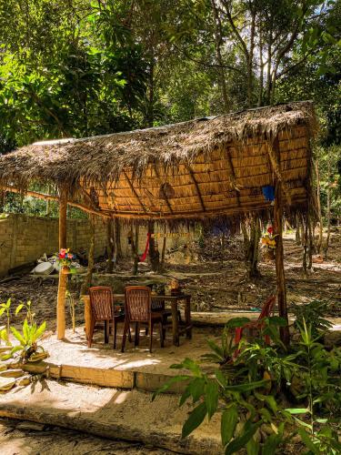a hut with chairs and a table in a yard at Sambath Sakseth Bungalow in Koh Rong Island