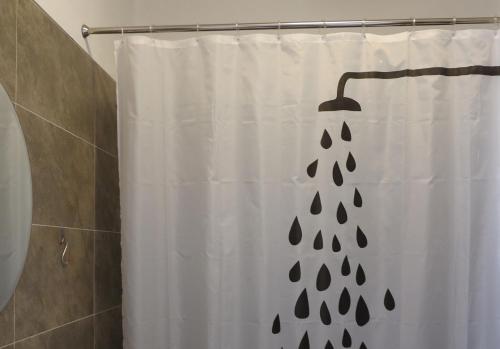 a shower curtain with a black and white shower at Villa Anna "Davvero sulla Spiaggia" in Vasto