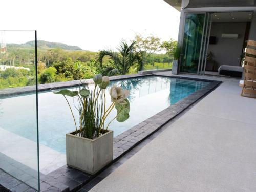 a villa with a swimming pool and a house at Phuket 4-Bedrooms Seaview 884m2 Private XL Luxury Infinity Pool Villa in Ban Pa Khlok