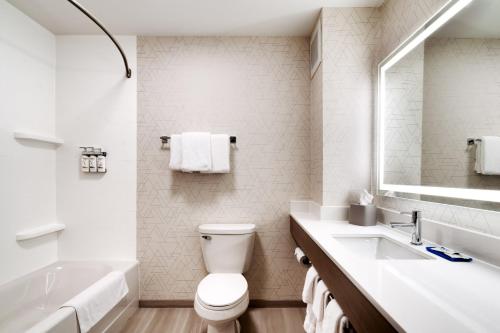 a white bathroom with a toilet and a sink at Holiday Inn Express Hotel & Suites Cheyenne by IHG in Cheyenne