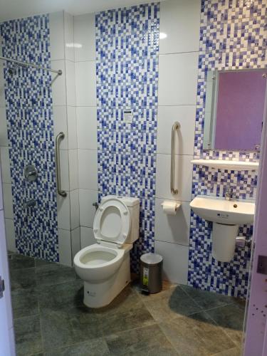 a bathroom with a toilet and a sink at Answer hotel in Puerto Galera